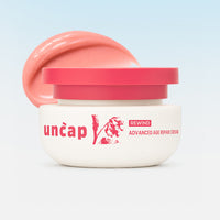 'uncap' advanced age repair cream with pink lid on a light blue background.