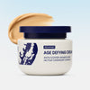Cream of Uncap age-defying cream with a swatch on a light blue background